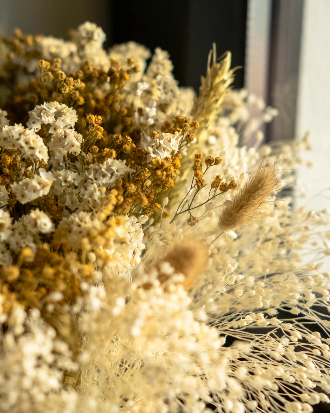 Cesto com flores secas e preservadas em tons dourado